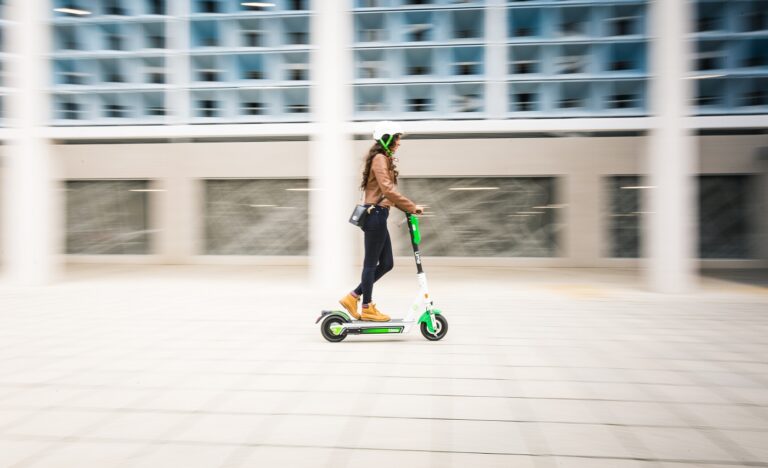 Ellie rides a Lime electric scooter at speed